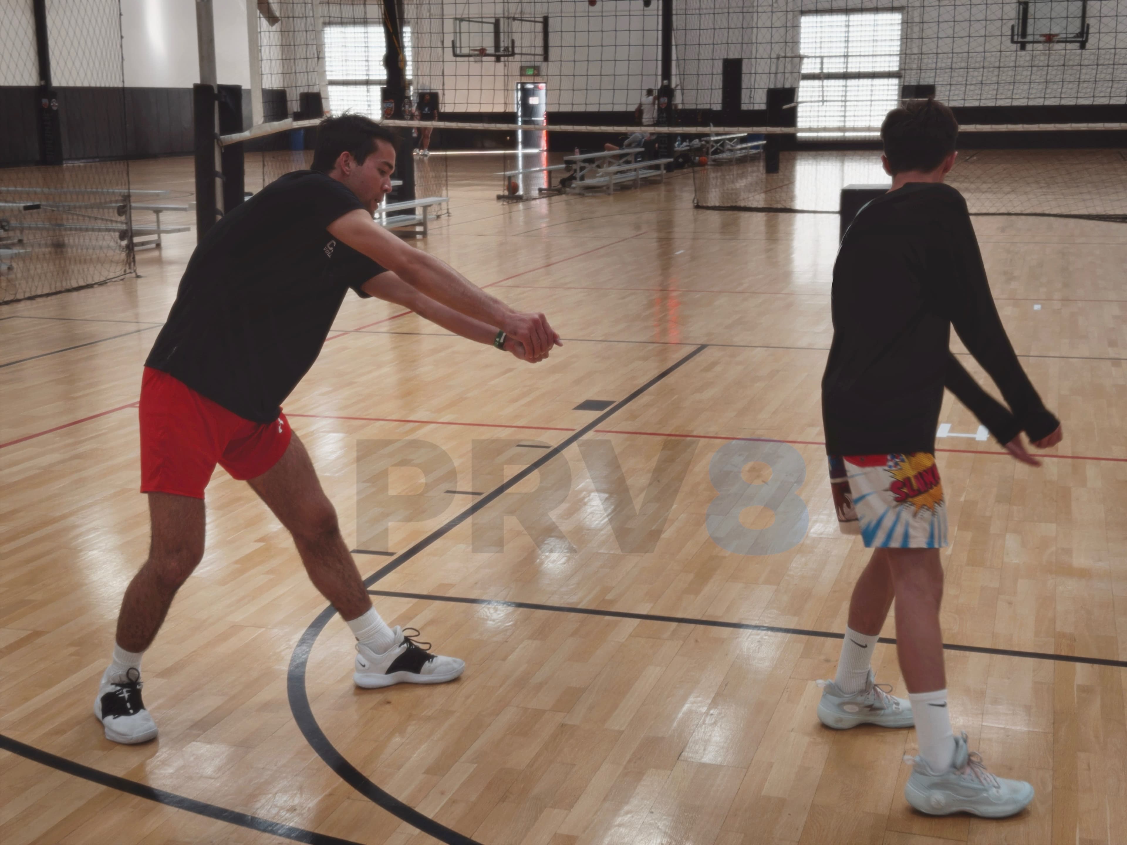 Coach demonstrating technique to athlete