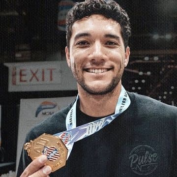 Silila 'Lila' Tucker, PRV8 founder, holding a gold medal courtside